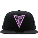 A black and violet Golden State Valkyries 59Fifty V’s Up After Dark Fitted Hat featuring a pink embroidered Golden Gate Bridge triangle logo on the front, released as a State Of Flux exclusive.