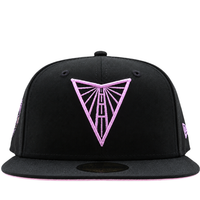 A black and violet Golden State Valkyries 59Fifty V’s Up After Dark Fitted Hat featuring a pink embroidered Golden Gate Bridge triangle logo on the front, released as a State Of Flux exclusive.