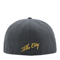 Graphite and black Golden State Warriors On Fire 59Fifty Fitted Hat featuring The City embroidered in yellow script on the front.