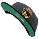 Golden State Warriors On Fire 59Fifty Fitted Hat in graphite and black featuring a green undervisor and a gold embroidered basketball logo topped with red and yellow flames.