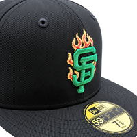 San Francisco Giants Burnin’ Green 59Fifty Fitted Hat in black and metallic green, featuring an embroidered green and orange flaming team logo on the front crown and a gold size sticker on the brim.