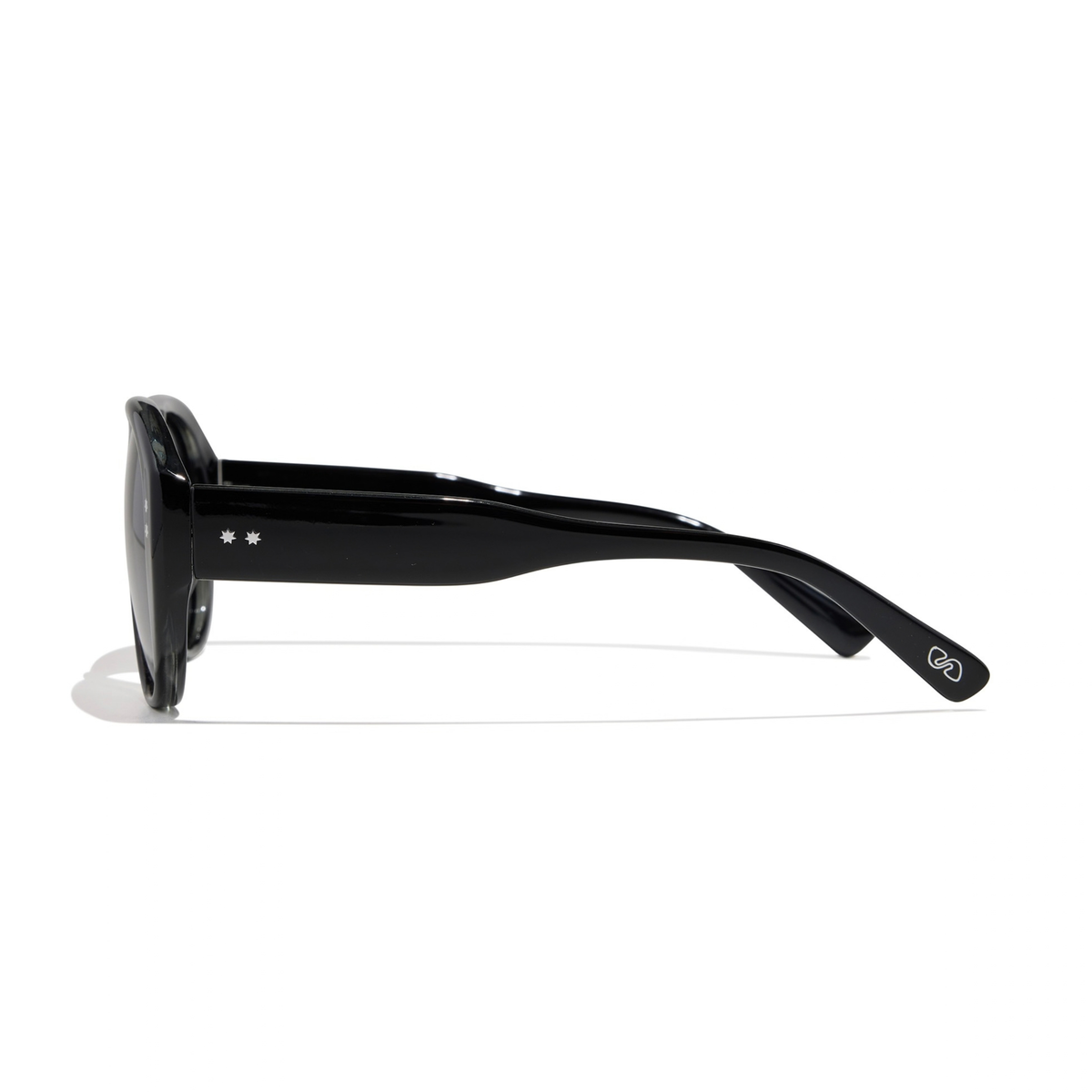 Side profile of oversized black Austin Sunglasses in elysium double black and ink polarized, featuring two small star icons on the temple.