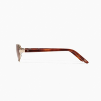 Side view of Cherry Sunglasses in polished gold and hazelnut, featuring oval lenses with gold metal frames and tortoiseshell-patterned arms.