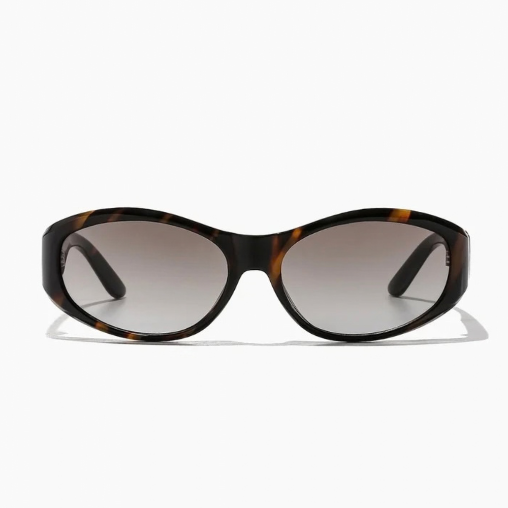 Brooks Sunglasses in tigers eye and dune, featuring an oval shape with a sustainable polycarbonate frame and gradient lenses.