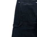 Close-up of Double Knee Canvas Shorts in black, featuring workwear-inspired design with a large front pocket, visible stitching, silver rivets, and a left-side belt loop.