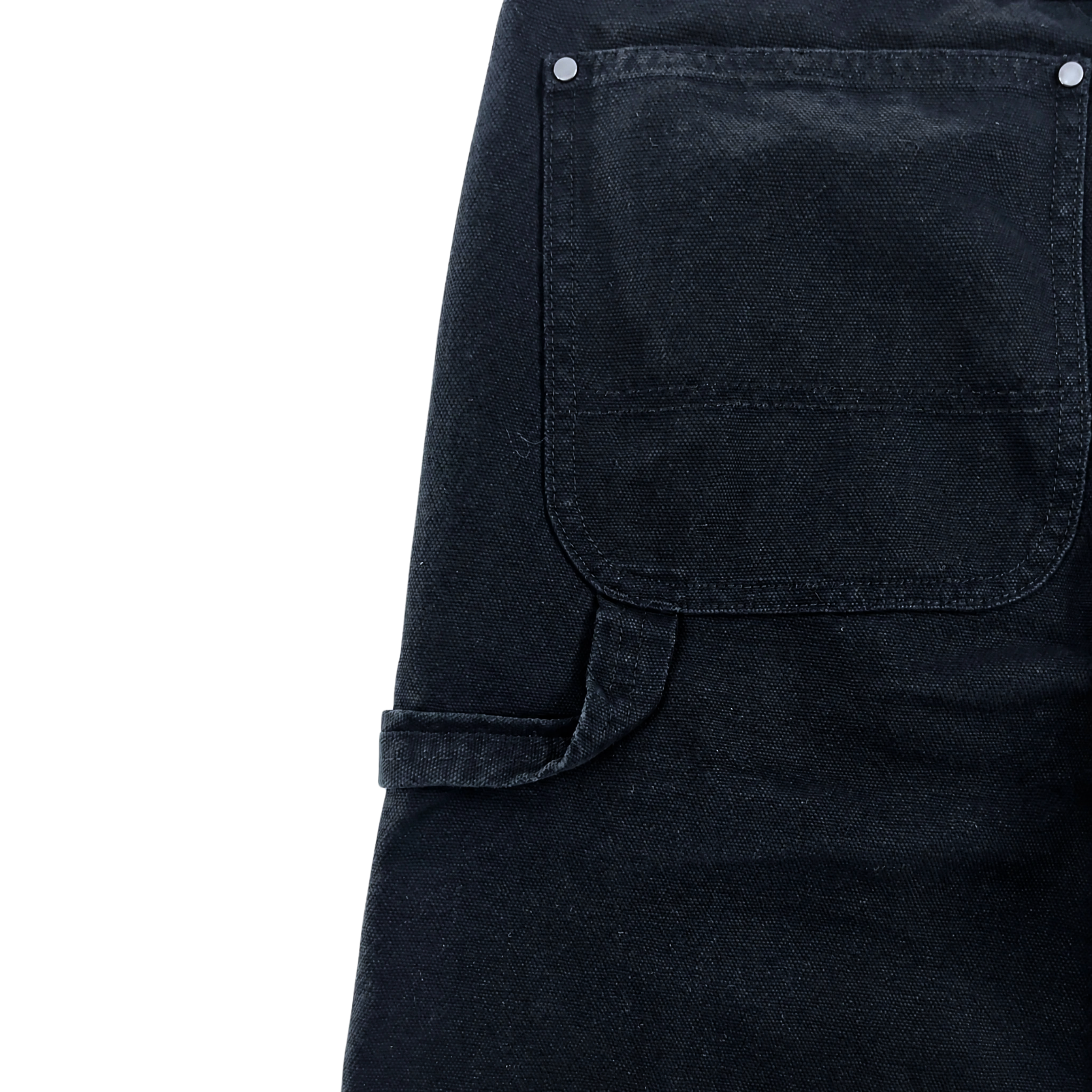 Close-up of Double Knee Canvas Shorts in black, featuring workwear-inspired design with a large front pocket, visible stitching, silver rivets, and a left-side belt loop.
