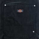Close-up of a black fabric pocket with silver rivets and a sewn-on Dickies logo patch, showcasing the durable construction of the Double Knee Canvas Shorts in black.