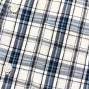 Close-up of the Springdale Short-sleeve Button-up Shirt in egret and blue, showing plaid cotton-linen fabric with intersecting black, blue, and gray lines on beige and two white buttons—a classic short-sleeve style.