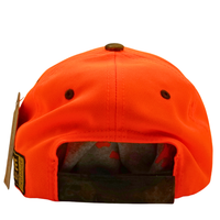 The image displays the back of the Peep Game Hat in safety orange and mossy oak, with a black adjustable strap, two ventilation holes, and a tag attached to this high-visibility outdoor headwear.