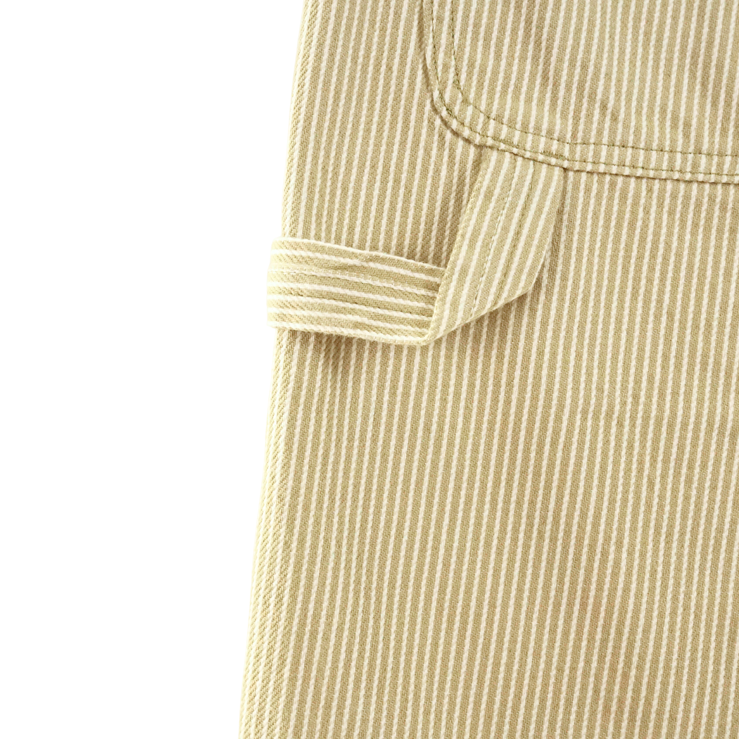 Close-up of the Hickory Stripe Carpenter Shorts in eucalyptus, featuring beige and white stripes, a stitched pocket, and fabric loop—showcasing signature Dickies workwear details.