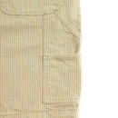 Close-up of beige and white vertically striped fabric with a stitched rectangular pocket and seam details, from Hickory Stripe Carpenter Shorts in eucalyptus, inspired by classic workwear shorts.