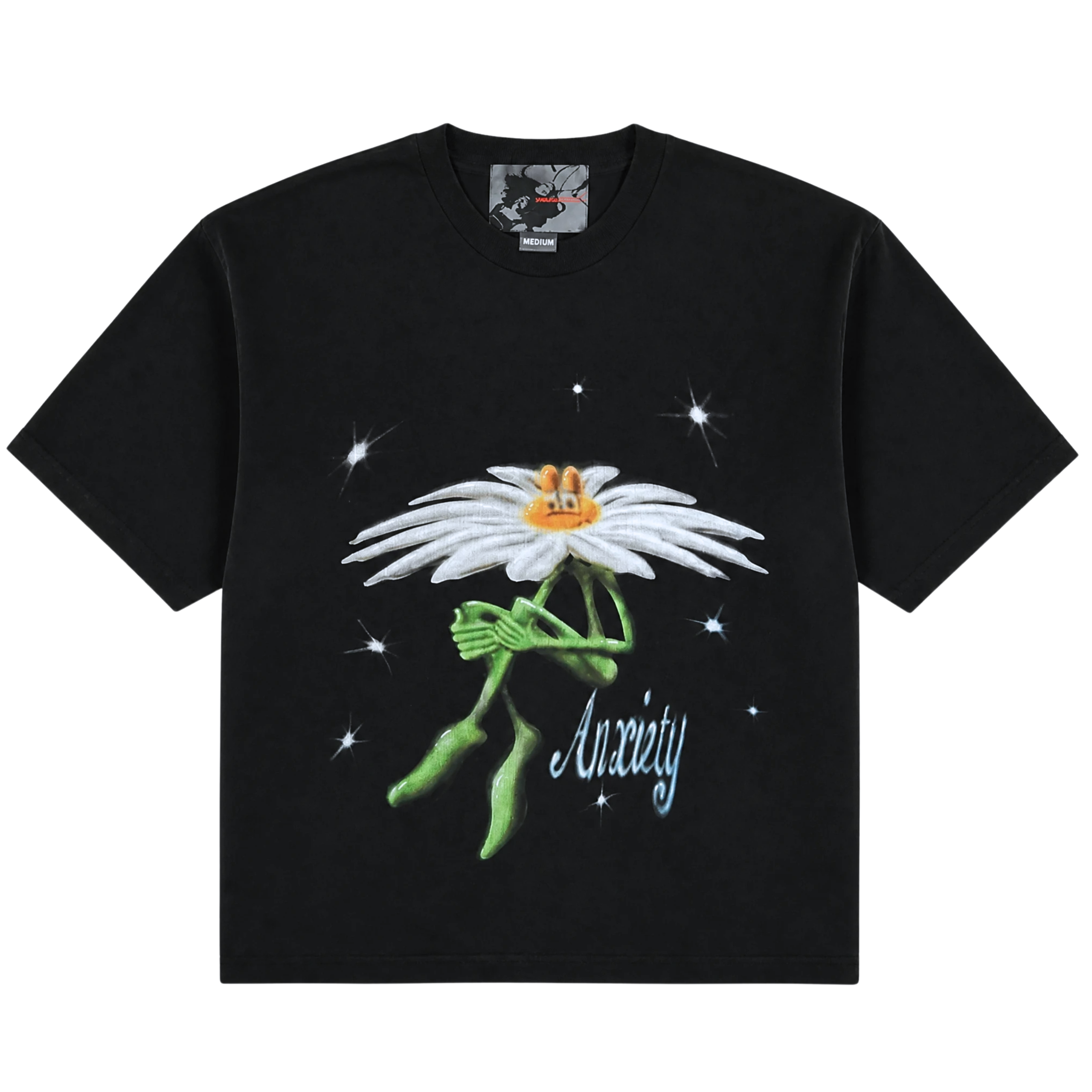 The Anxiety Flower Tee in black features a cartoon daisy with a worried expression, green arms and legs, surrounded by stars, and the word "Anxiety" written below in cursive white text. This unique heavyweight cotton tee blends streetwear style with bold everyday appeal.