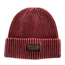Introducing the Ribbed Knit Mantra Beanie in washed burgundy—a cozy red beanie crafted from a soft rayon blend, featuring a folded brim and a rectangular patch that displays “STATE OF FLUX” alongside an inspiring motivational quote in smaller lettering.