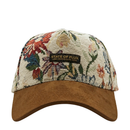 Introducing the Wildflower Strapback Hat in cream and brown—a jacquard woven baseball cap featuring intricate floral artwork and a brown suede brim. The front patch displays “State of Flux, San Francisco, USA.”.