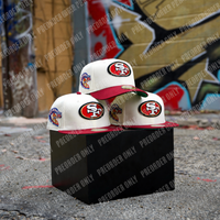 Three chrome white and cardinal San Francisco 49ers Surfin’ Garcia 59FIFTY fitted hats are displayed on a black box outdoors against a graffiti-covered wall. “PREORDER ONLY” text is overlaid repeatedly.