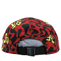 A Zippered Psycapdelic 5-Panel Hat in blood red and bright yellow, shown from the back, featuring yellow graffiti-style lettering. It has a black adjustable strap, a small opening above the strap, and showcases classic streetwear appeal.