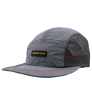 Introducing the SOF Active 5-Panel Cap in steel: a lightweight, water-resistant nylon cap featuring a gray (steel) colorway, red stitching, and a mesh back for breathability. Designed with a curved brim and sporty modern style, it’s finished with a front patch that reads STATE OF FLUX in bold yellow letters.