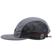 Introducing the SOF Active 5-Panel Cap in steel—a lightweight gray hat crafted from water-resistant nylon. This cap features bold red stitching, a flat brim, and black mesh side panels for ventilation. The back is finished with a small reflective patch and an adjustable red drawstring for a secure fit.