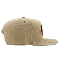 A beige San Francisco 49ers Big Logo Visor 9FIFTY Snapback Hat, shown from the side, features a large embroidered patch on the front and stylish stitching on the brim for a classic look in the signature New Era 9FIFTY silhouette.