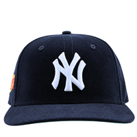 A navy corduroy New York Yankees Seinfeld 59Fifty fitted hat featuring a white logo on the front, shown from the front view.