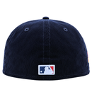 A New York Yankees Seinfeld Corduroy 59Fifty Fitted Hat in navy and white, shown from the back, features the MLB logo patch centered near the bottom edge. This classic design evokes a timeless style that fans of both Yankees fitted hats and Seinfeld New Era caps will recognize and appreciate.