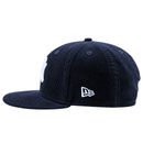 The New York Yankees Seinfeld Corduroy 59Fifty Fitted Hat in navy and white is crafted from navy blue corduroy with a flat brim, and features a white embroidered logo on the front and a smaller white logo on the side.