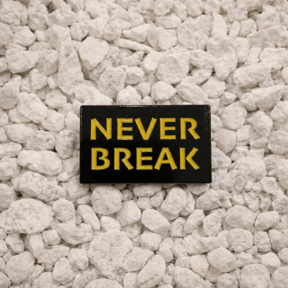 Never Break Pin in black and yellow