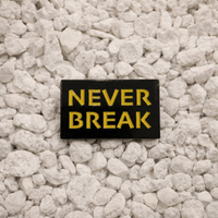 Never Break Pin black and yellow 1.25-inch soft enamel dual-post with black rubber backers