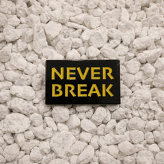 Never Break Pin in black and yellow