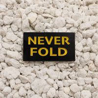 Never Fold Pin black and yellow 1.25in soft enamel dual post with black rubber backers