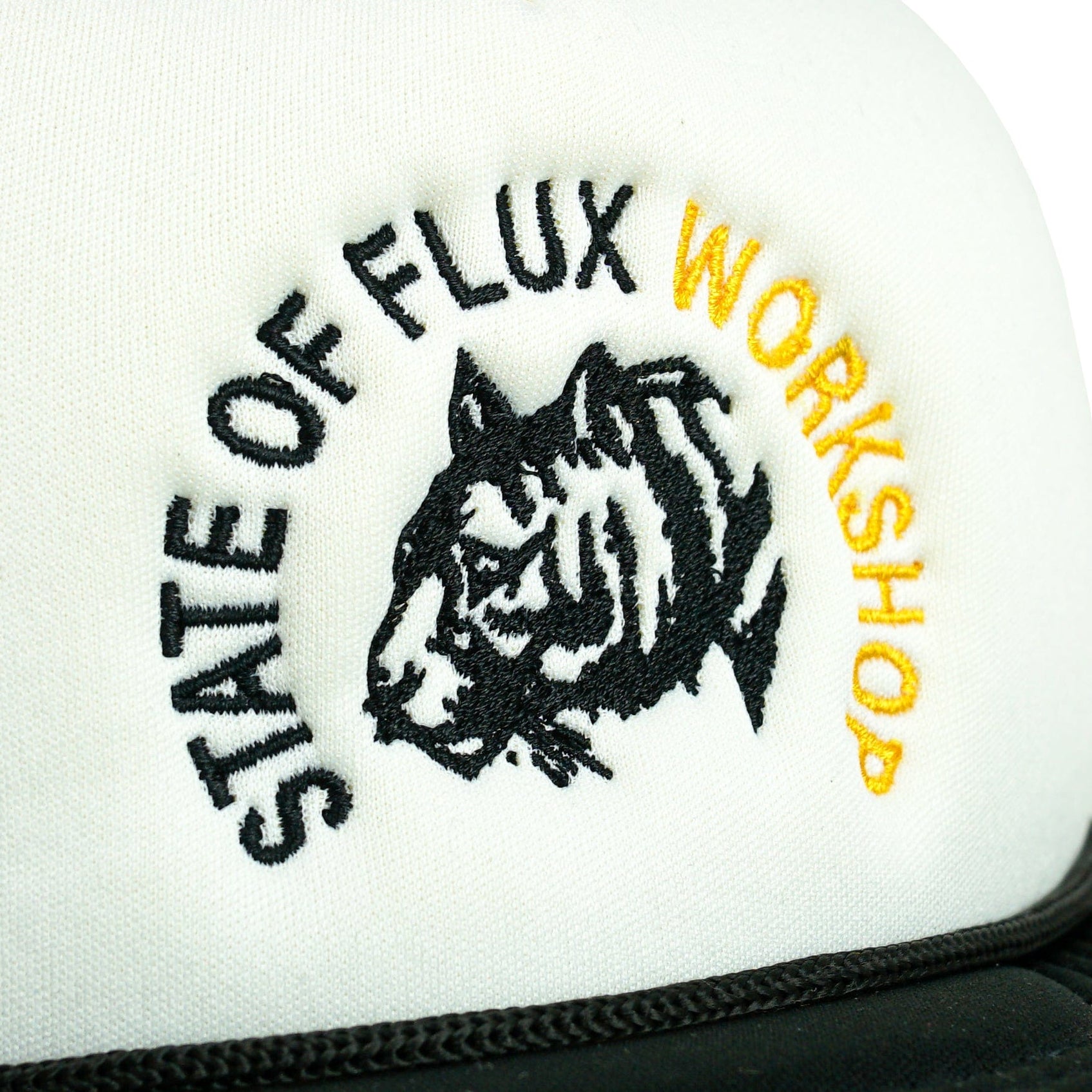 The Workshop Trucker Hat in black and white